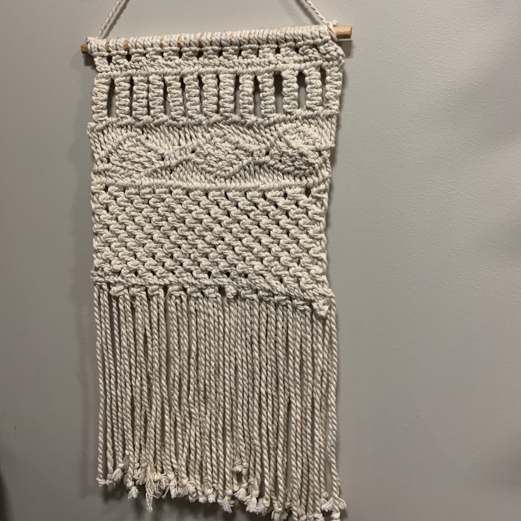 Handmade macrame wall hanging with knotted cotton cord and a long fringe, listed by a US resale seller